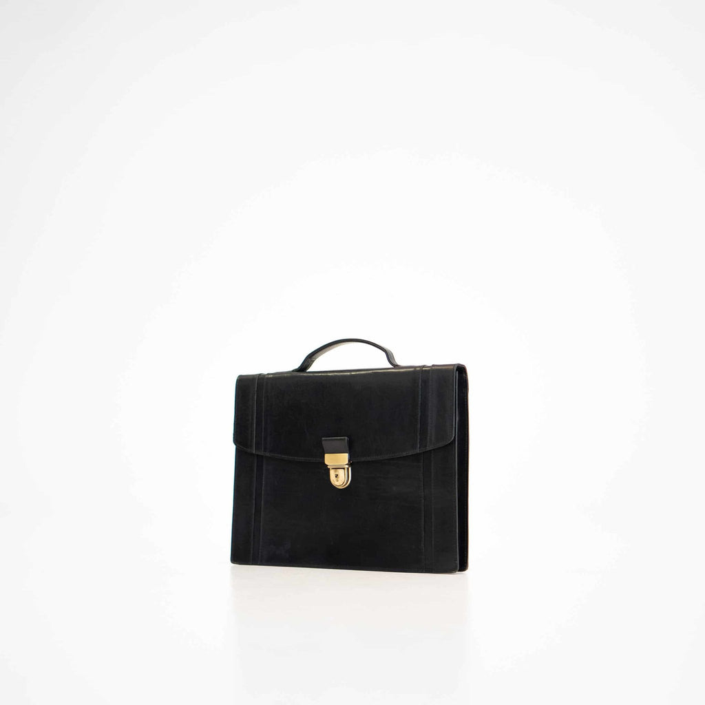 1. Papillon Briefcase No. 21 in black leather, front view with gold clasp, studio setting
