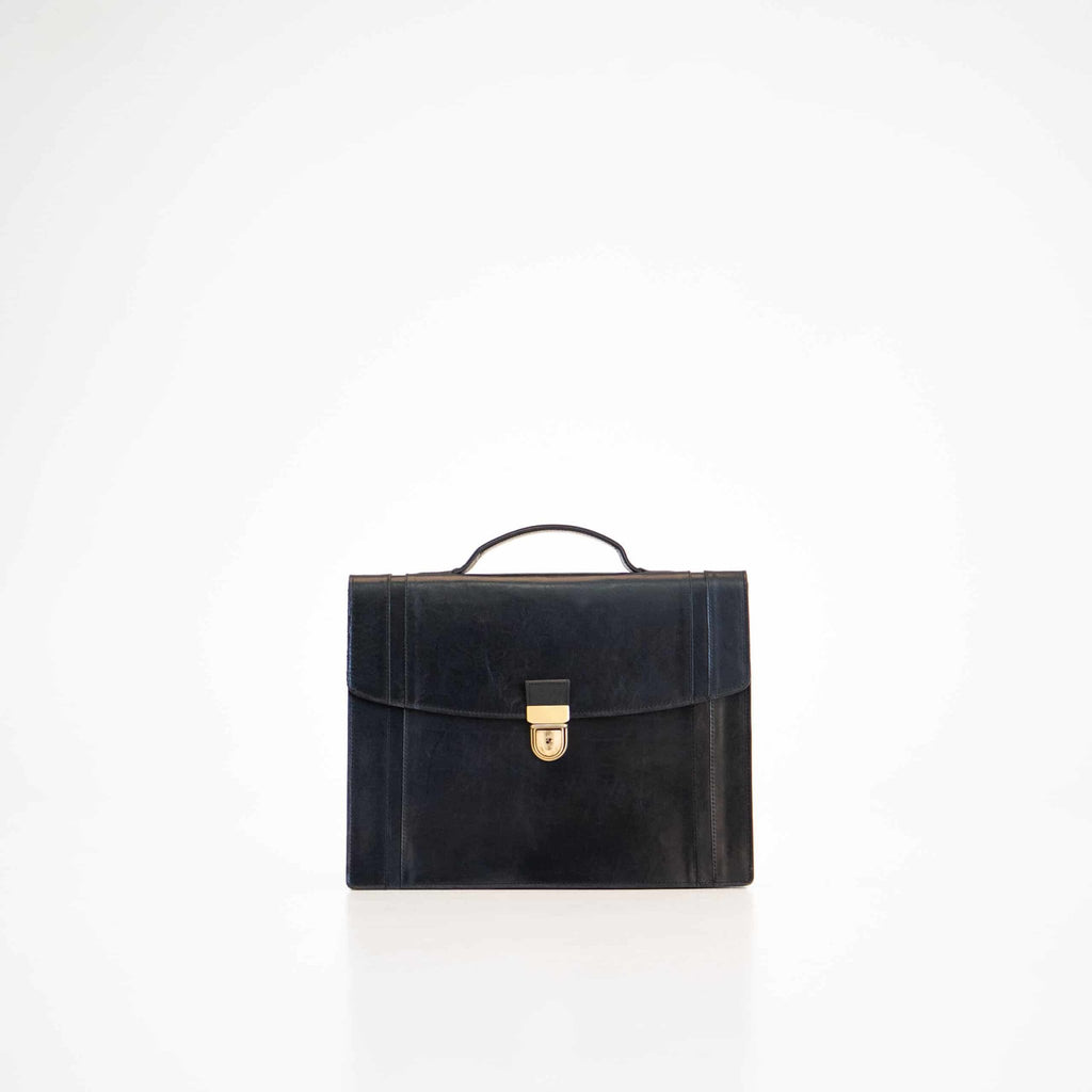 3. Papillon Briefcase No. 21 in black leather, front view with handle, studio setting