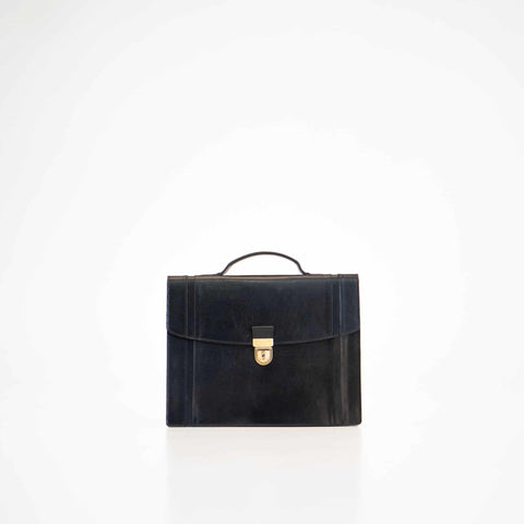 3. Papillon Briefcase No. 21 in black leather, front view with handle, studio setting