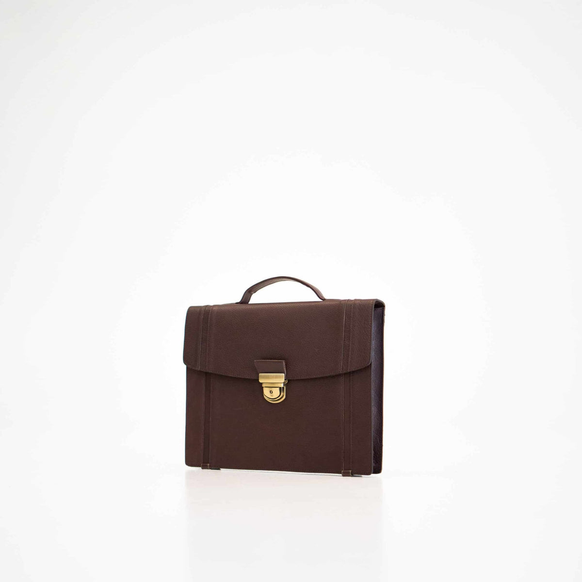 1. Papillon Briefcase No. 21 in dark brown leather, front view with gold clasp, studio setting