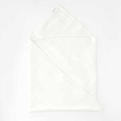 2. White linen hooded waffle towel for kids laid flat on a clean white background