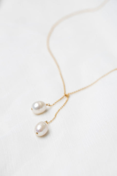 3. Close-up of TIED TO COCO - Pearl necklace by New Vintage by Kriss, highlighting two large pearls on a delicate gold-filled chain