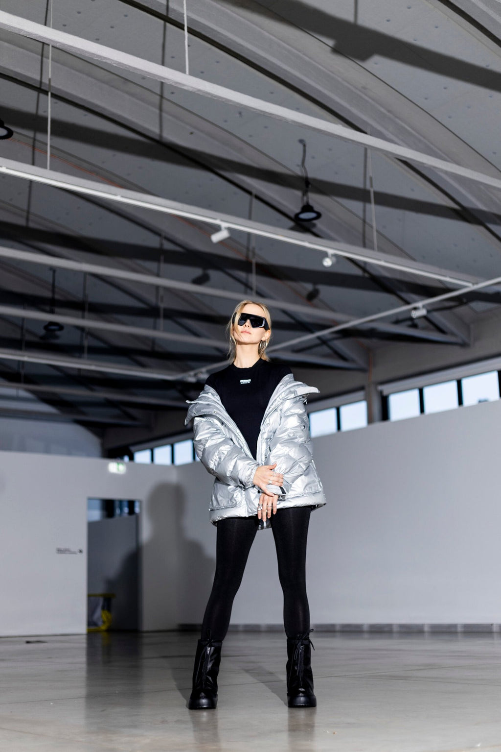 2. Woman in Samelin overboots and silver jacket, highlighting winter fashion in a modern setting