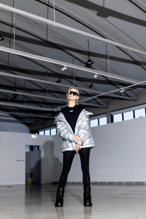 2. Woman in Samelin overboots and silver jacket, highlighting winter fashion in a modern setting