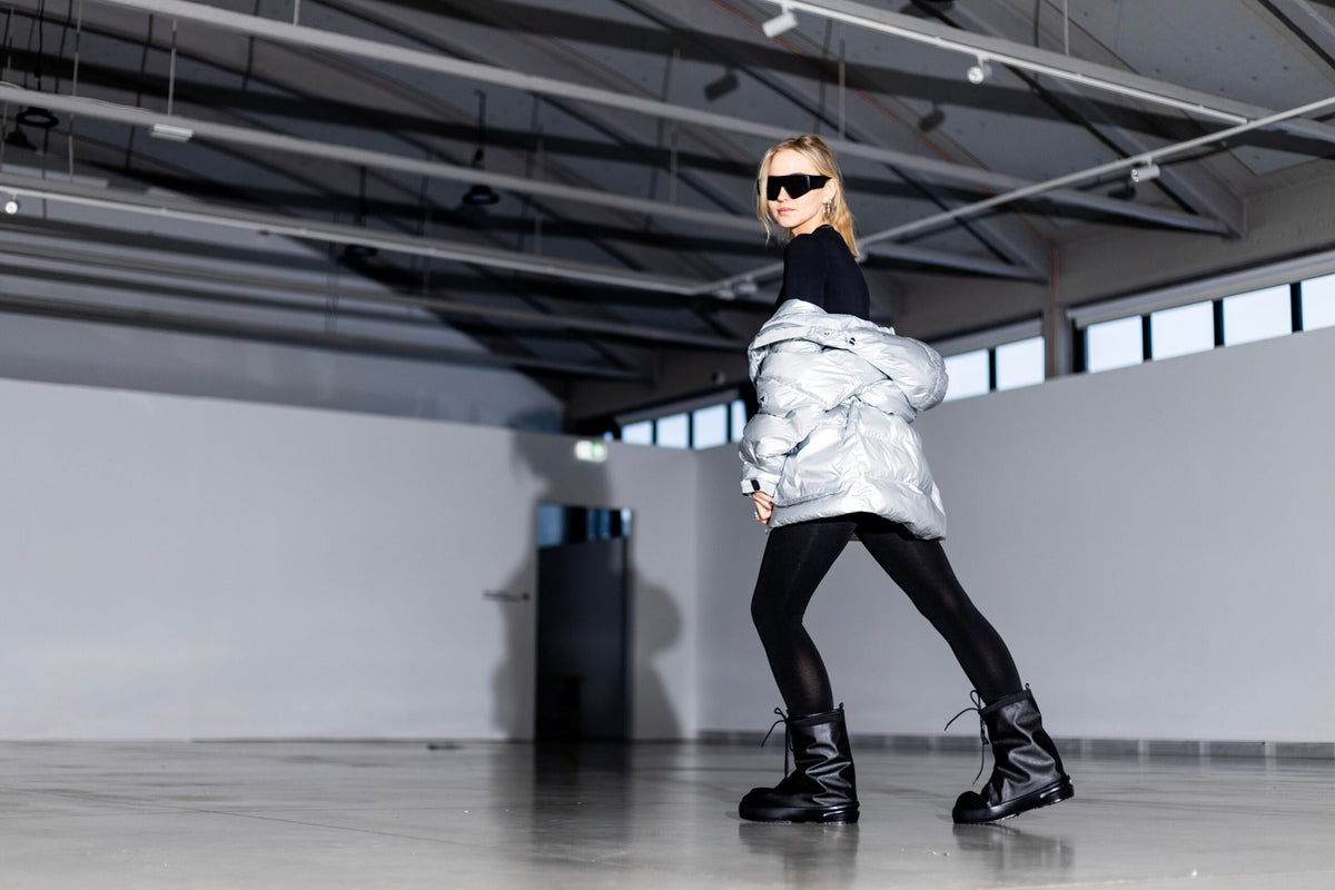 3. Woman walking confidently in Samelin overboots, demonstrating comfort and waterproof design