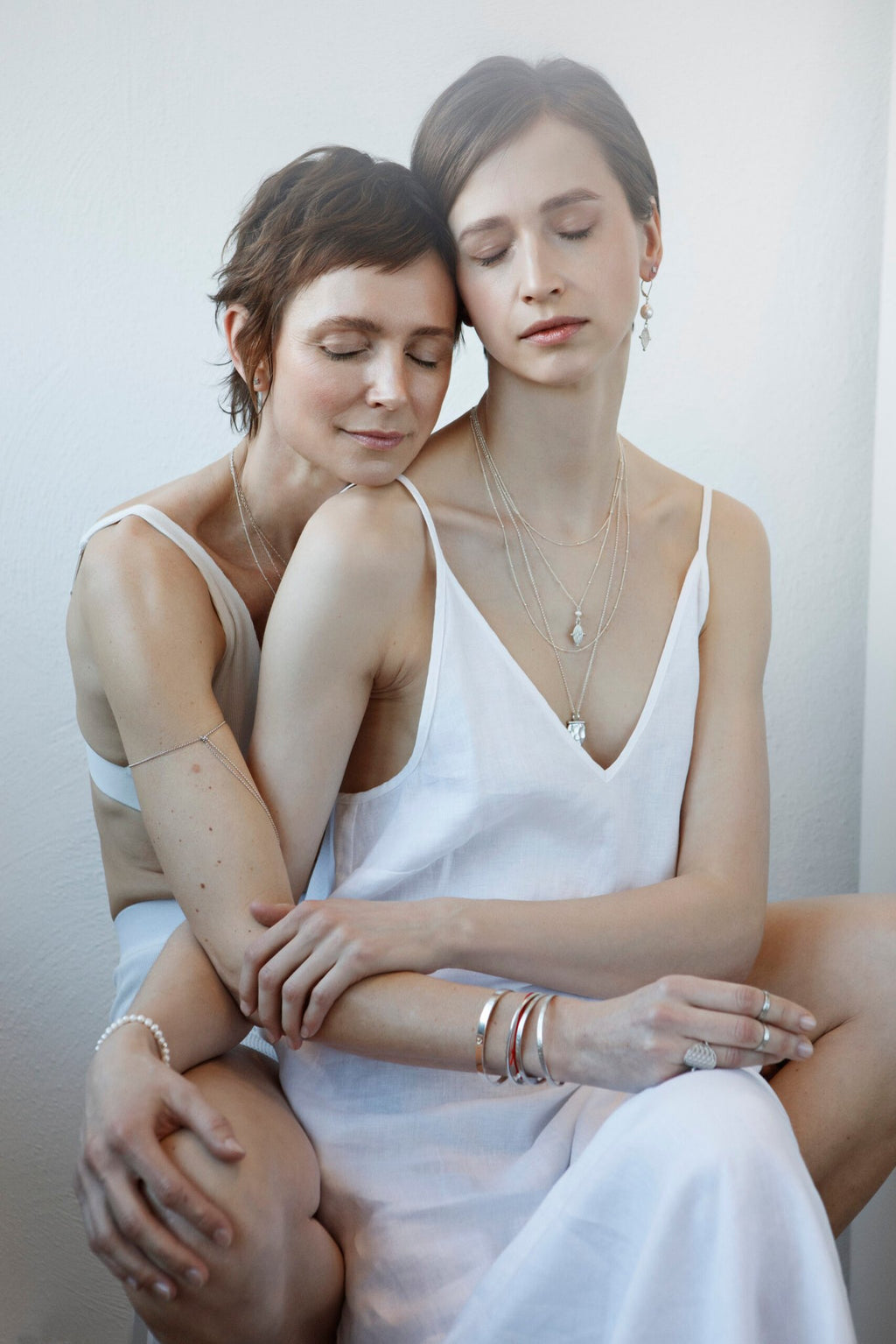 1. Women's Morning Star Necklace in silver by New Vintage by Kriss, worn by two women in a lifestyle setting
