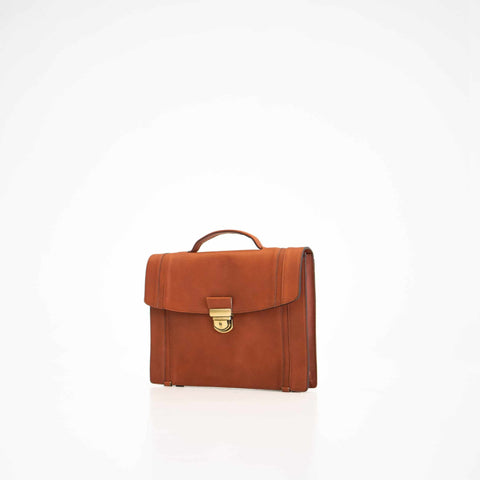 1. Papillon Briefcase No. 21 in cognac leather, front view with gold clasp, studio setting