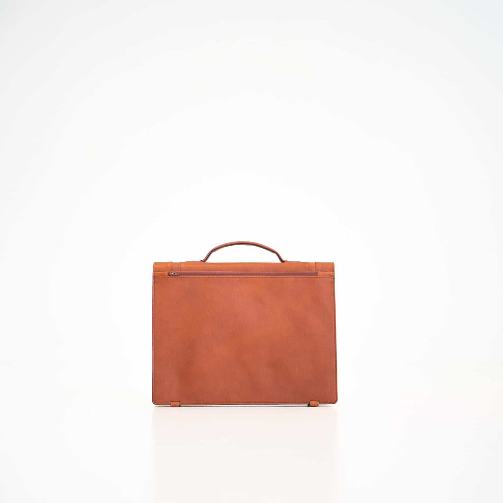 2. Back view of Papillon Briefcase No. 21 in cognac leather, showing zip pocket, studio setting