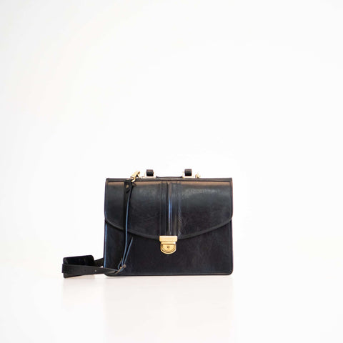5. Papillon Briefcase No. 20 in black leather with removable shoulder strap, studio shot