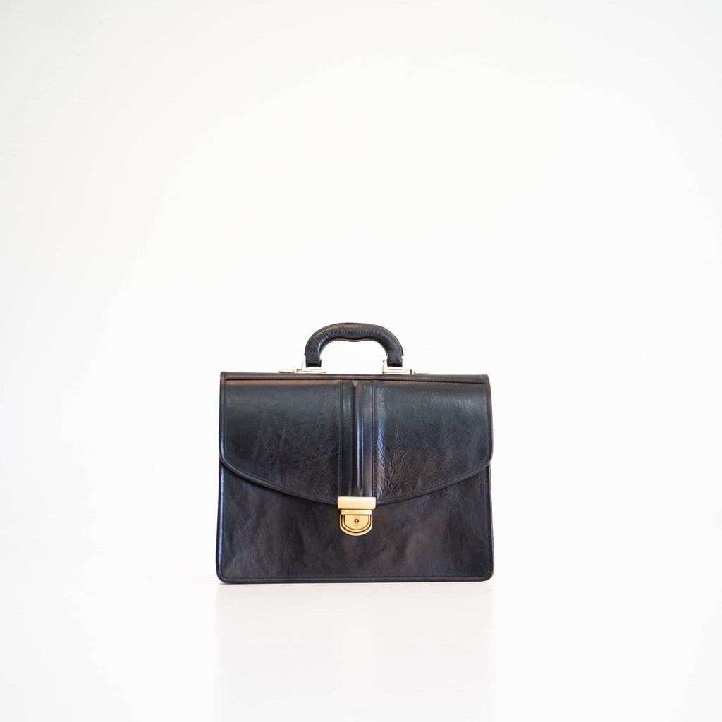 3. Front view of Papillon Briefcase No. 20 in black leather, highlighting gold clasp and handle