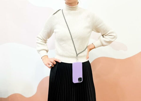 2. Woman wearing SEIK Universal Phone Strap in Sea Edge with purple phone case, hands-free style