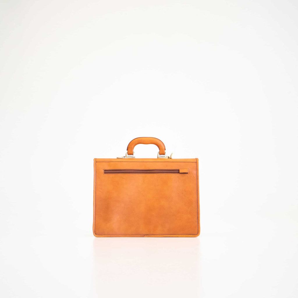 4. Back view of Papillon Briefcase No. 20 in cognac leather, featuring zippered pocket