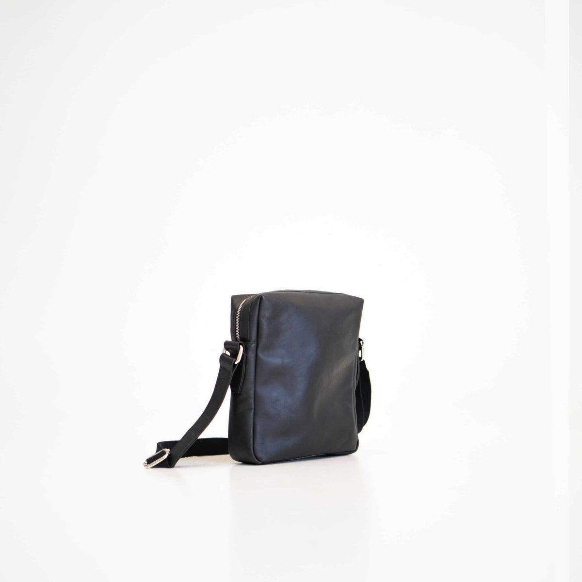 2. Studio shot of Papillon Small Shoulder Bag No. 37 in black leather, side view highlighting adjustable strap