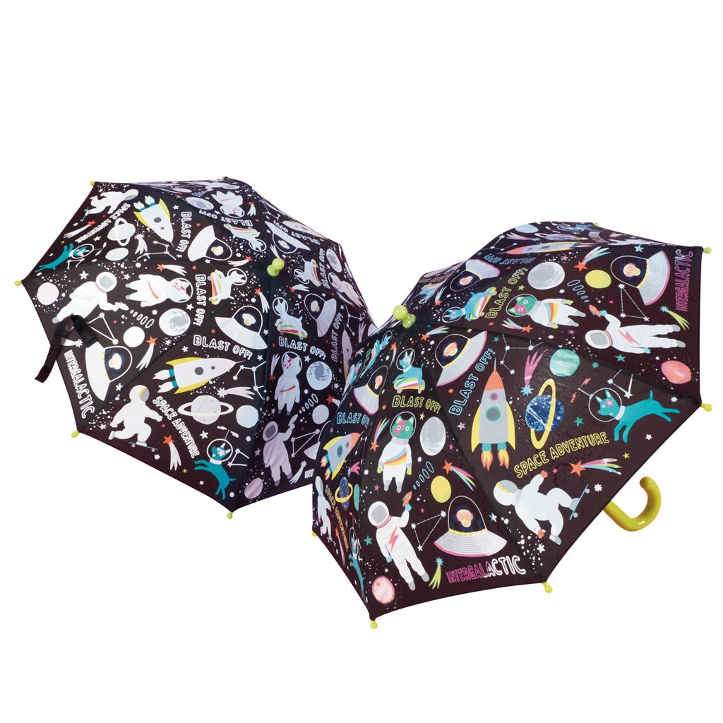 1. Two Floss & Rock color-changing umbrellas with space-themed designs, featuring rockets and astronauts, shown in both dry and wet states with colorful motifs on a white background.