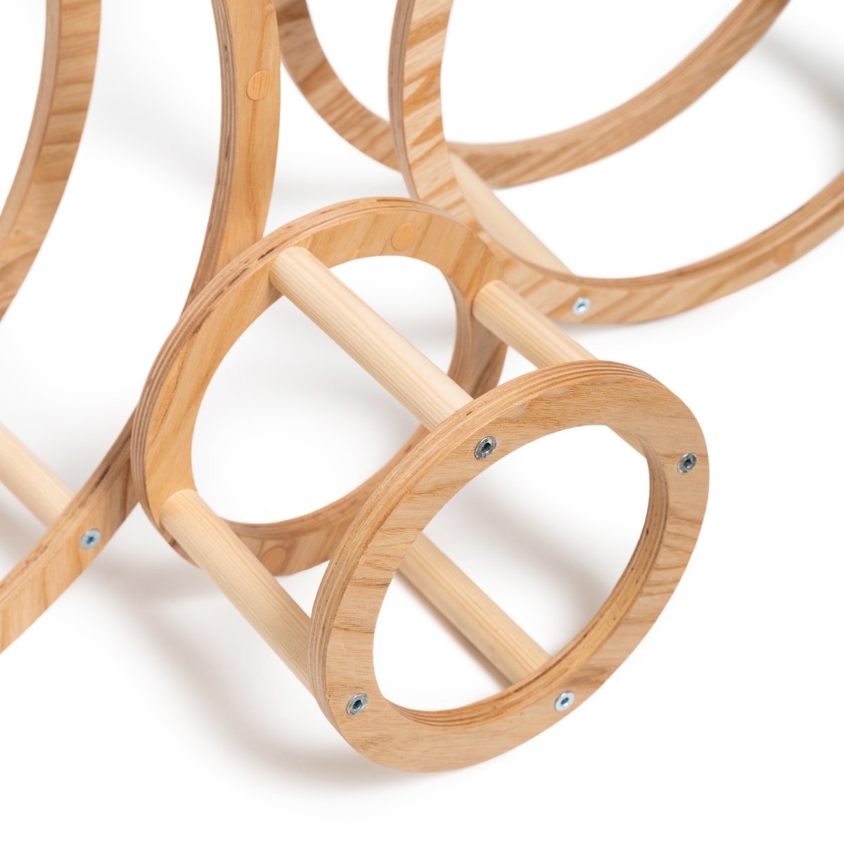 4. Close-up of wooden ring with dowels connecting two circular frames, highlighting construction details
