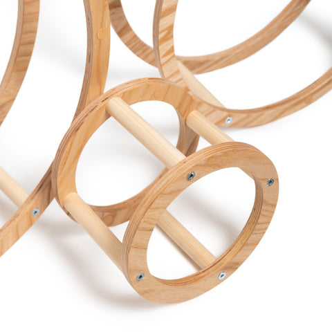 4. Close-up of wooden ring with dowels connecting two circular frames, highlighting construction details