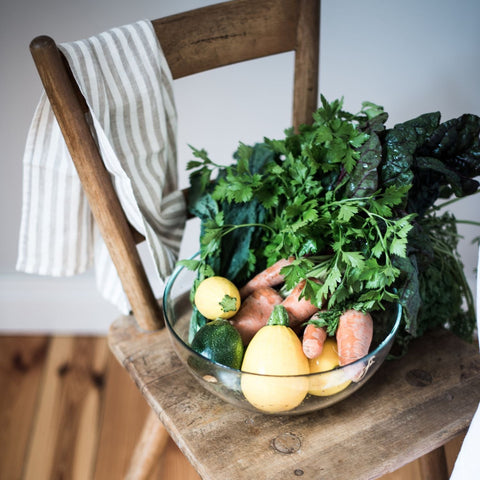 5. Striped linen kitchen towel draped over chair with bowl of fresh vegetables