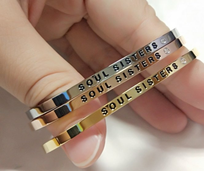 3. Close-up of Olla's Soul Sisters bracelets in silver, rose gold, and gold, showing engraved message and polished finish