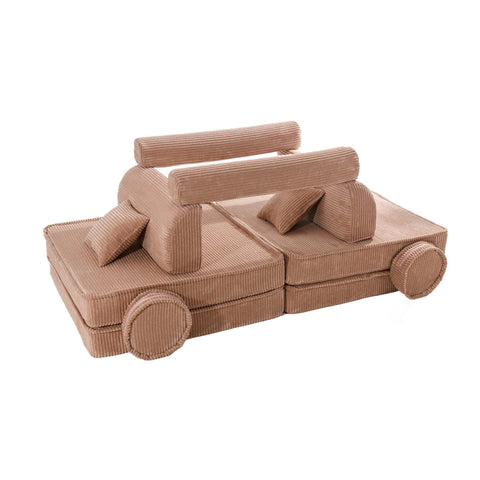 3. Creative arrangement of modular children's sofa pieces in powder pink corduroy resembling a car
