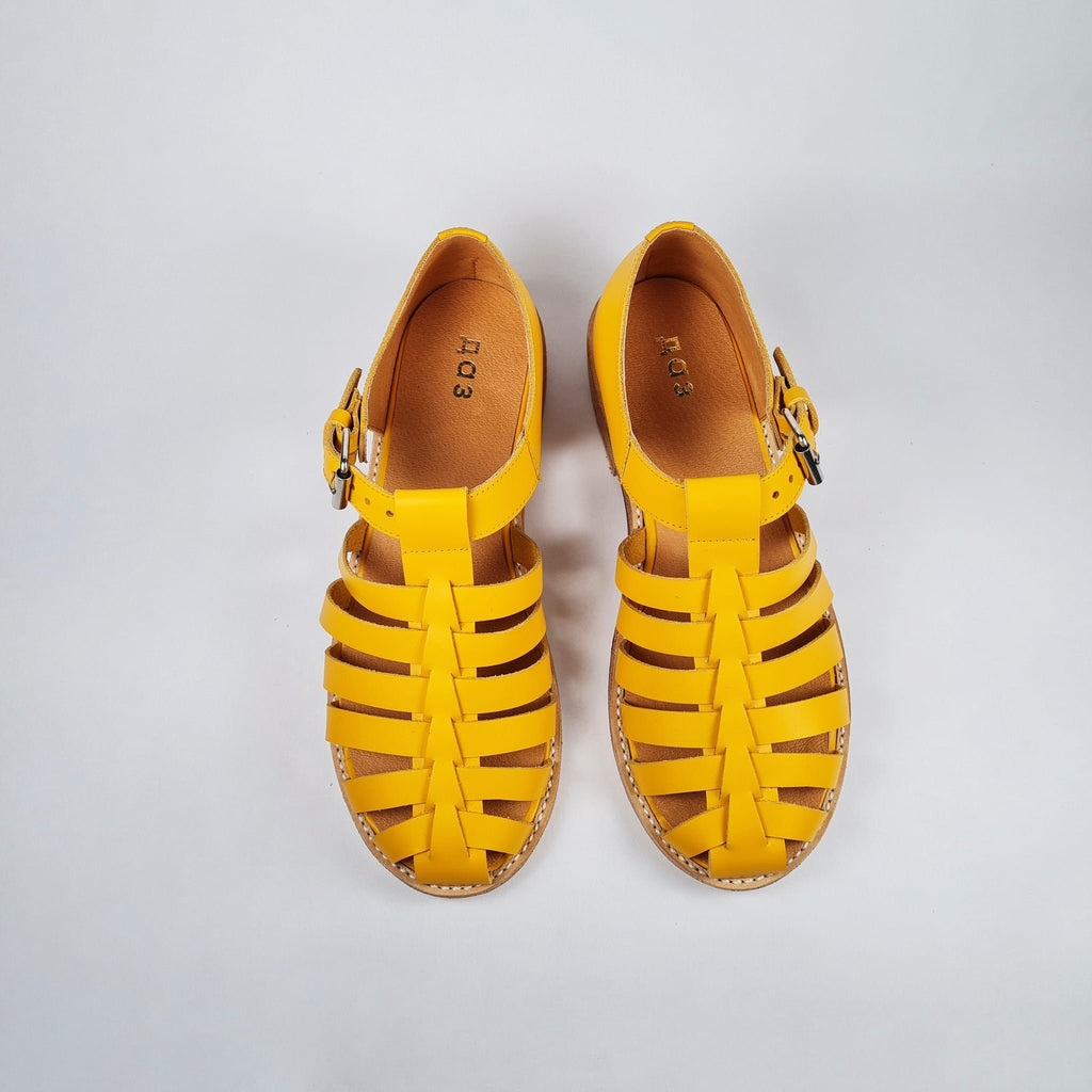 3. Top view of Daz Studio's yellow handmade leather fisherman sandals with adjustable buckle
