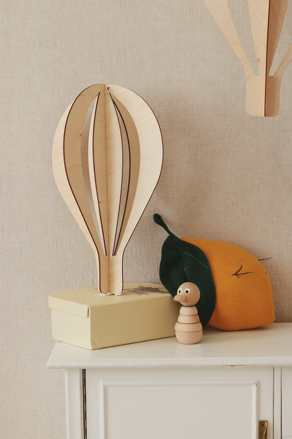 2. Single birch plywood hot air balloon decoration on cabinet with yellow box and plush fruit