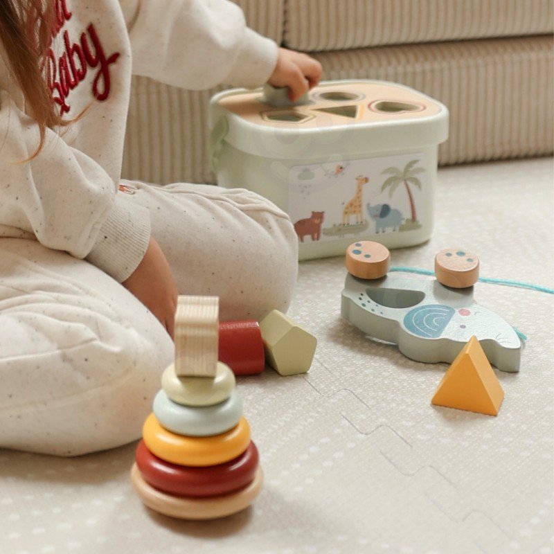 1. Child playing with Woopie Let's Go Green 3in1 toy box set on carpet, featuring sorting blocks, stackable pyramid, and elephant on wheels