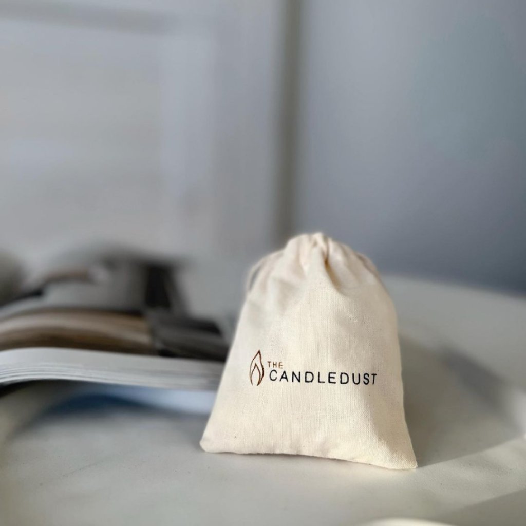 2. Candledust branded drawstring bag on a table, ideal for storing extra wicks
