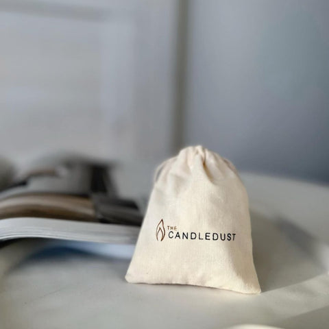 2. Candledust branded drawstring bag on a table, ideal for storing extra wicks