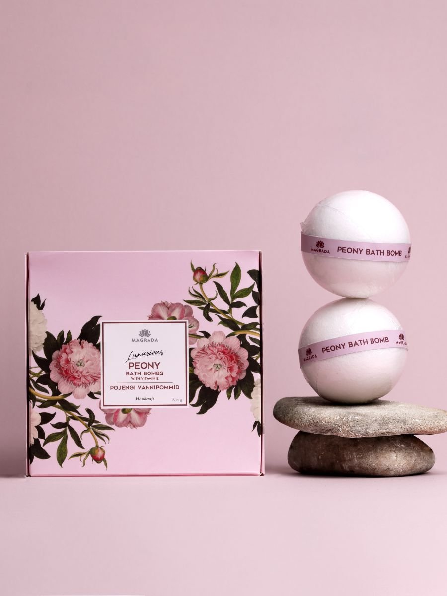 1. Luxurious Peony Bath Bomb set by Magrada Organic Cosmetics, featuring two bath bombs and floral packaging, styled on stones against a pink background