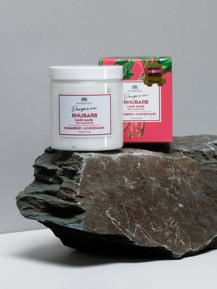 2. Magrada Organic Cosmetics Rhubarb Hair Mask jar and box on stone surface, highlighting award-winning packaging