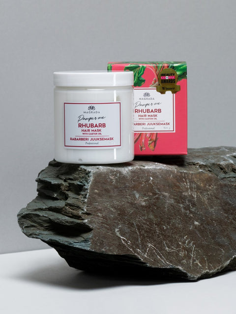 2. Magrada Organic Cosmetics Rhubarb Hair Mask jar and box on stone surface, highlighting award-winning packaging
