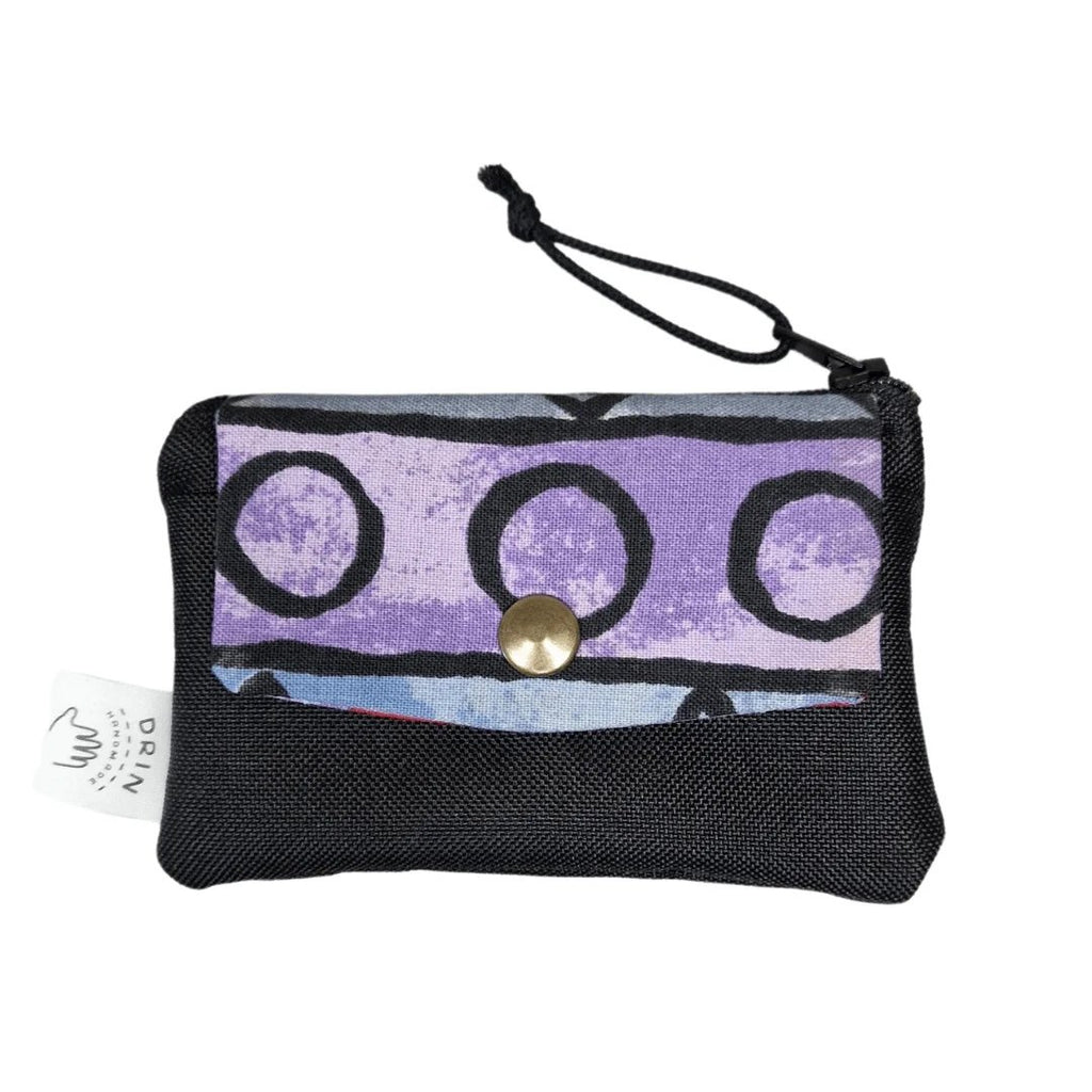 3. Drinbags ZIG ZAG wallet in reused fabric with purple and black pattern, featuring a metal press button and zipper closure, shown in studio