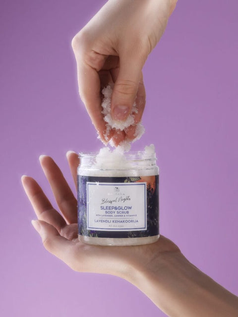 1. Woman applying Magrada Organic Cosmetics Lavender Body Scrub with Grapefruit Essential Oil, showcasing texture and packaging
