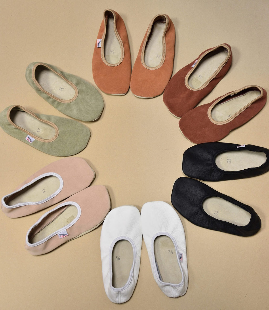 4. Flat lay of Hip-Hop barefoot slippers in various colors including terracotta, green, and black, arranged in a circle