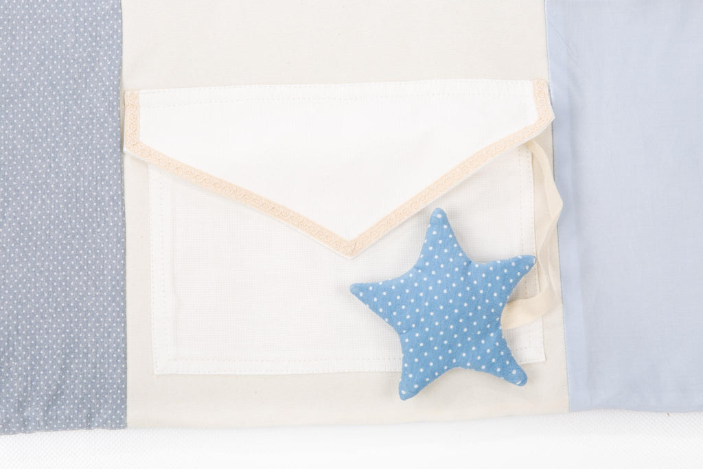 3. Close-up of blue polka dot star toy attached to a white envelope pocket on Karloova activity mat