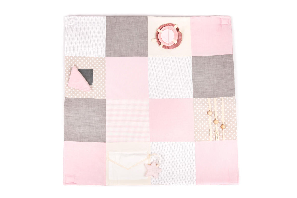 4. Flat lay of Karloova pink and grey patchwork baby activity mat with various textures