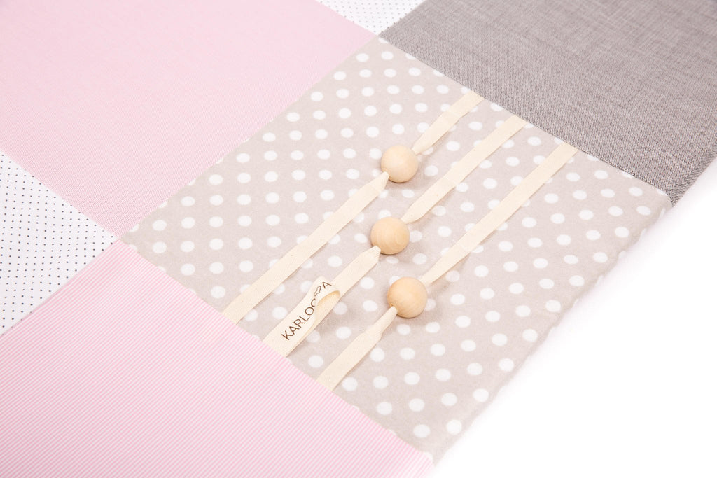 3. Close-up of wooden buttons on polka dot section of baby activity mat