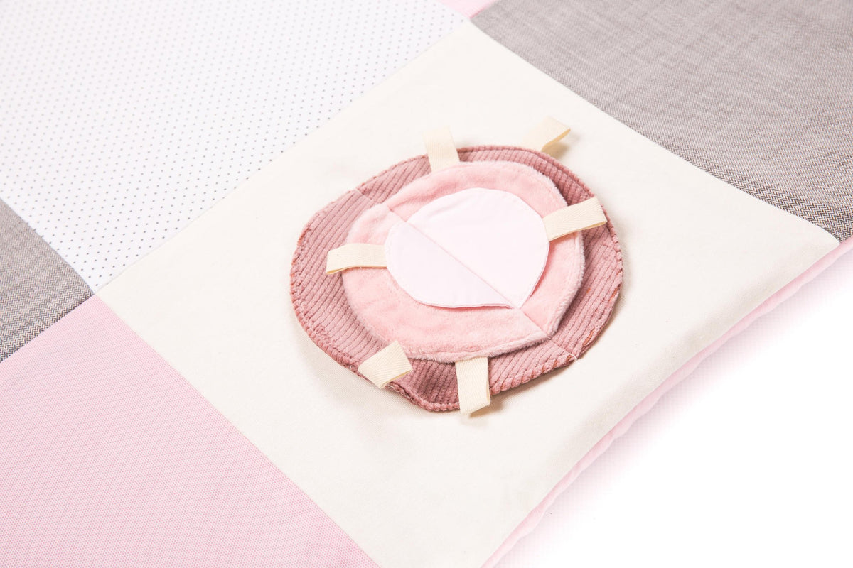 3. Close-up of pink circular fabric detail on baby activity mat