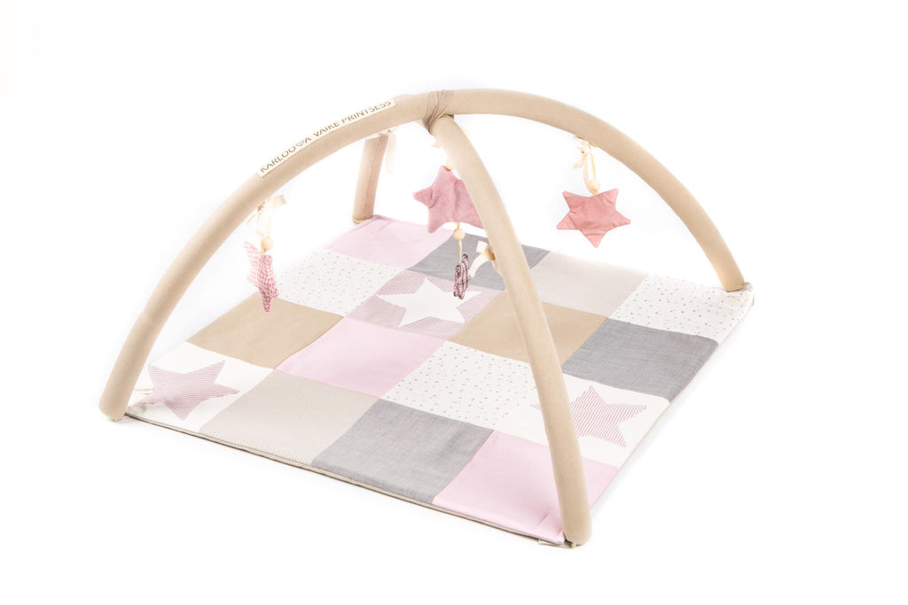 1. Karloova pink baby activity mat with arches and star toys in a patchwork design on a white background