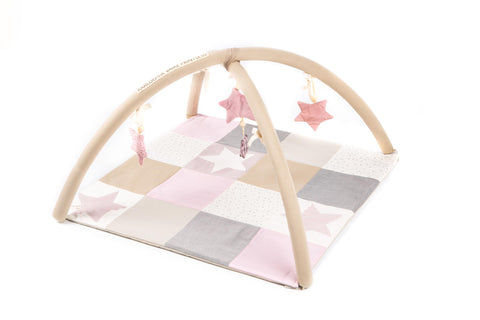 1. Karloova pink baby activity mat with arches and star toys in a patchwork design on a white background