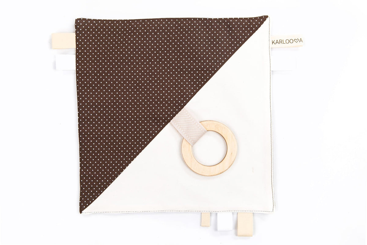 2. Studio shot of Karloova comfort blanket with wooden hoop and brown polka dot design