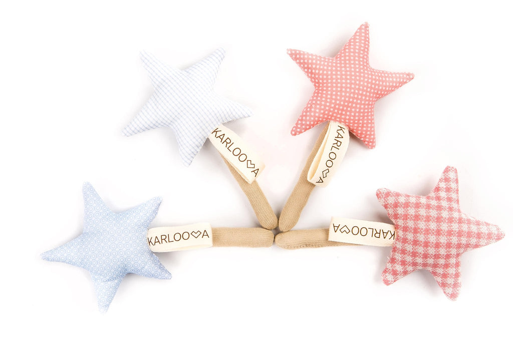 8. Four Karloova Magic Wands in blue and pink star shapes with beige handles on white background