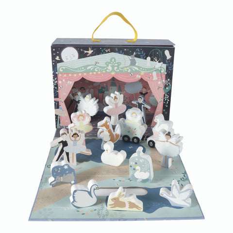 1. Enchanted playbox with wooden characters including ballerinas and swans on a stage with a magical forest backdrop