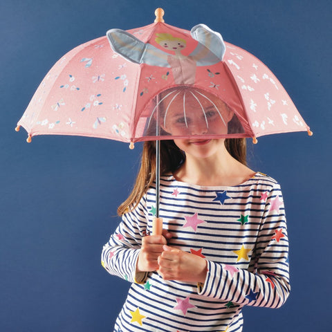 1. Girl holding pink color-changing umbrella with fairy design and 3D elements, wearing striped shirt with star patterns, against blue background