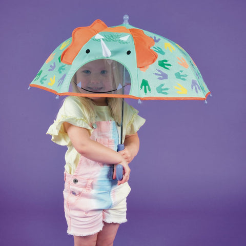1. Child holding a color changing 3D dinosaur umbrella with colorful motifs on a purple background