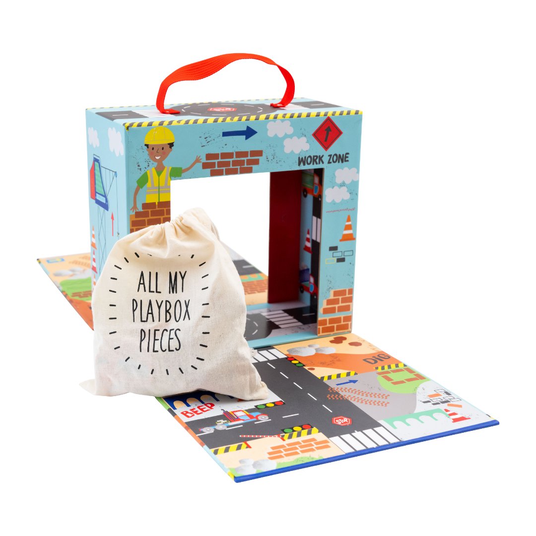 7. Playbox with drawstring bag labeled 'All My Playbox Pieces' on a colorful construction-themed play area