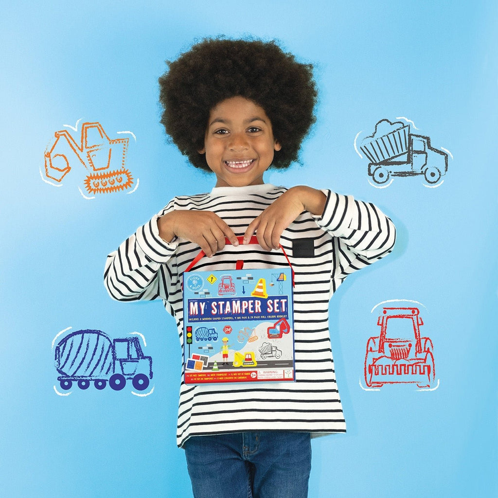 1. Child holding My Stampler Set against blue background with construction vehicle illustrations