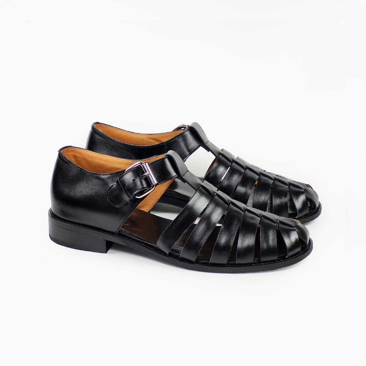 3. Side view of men's black leather fisherman sandals with adjustable strap and buckle, studio shot
