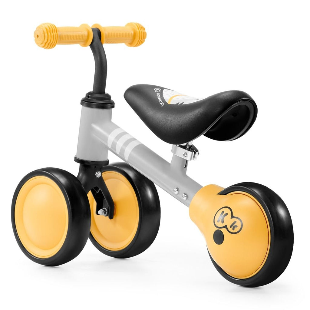 14. Studio shot of yellow Kinderkraft CUTIE balance bike with three wheels and kitten print