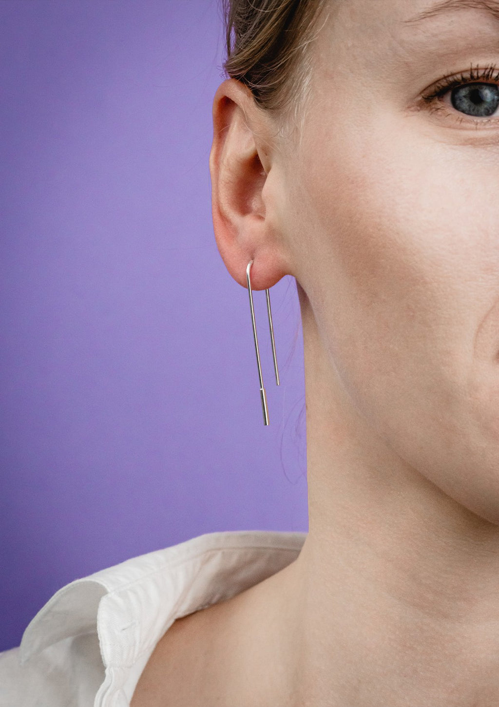 2. Close-up of women's U-shaped silver earrings by Maarja Palu, highlighting sleek design